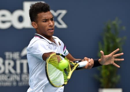 FILE PHOTO: Mar 29, 2019; Miami Gardens, FL, USA; Felix Auger-Aliassime of Canada returns a shot back to John Isner of the United States (not pictured) during the men's semi-final at the Miami Open at Miami Open Tennis Complex. Mandatory Credit: Steve Mitchell-USA TODAY Sports