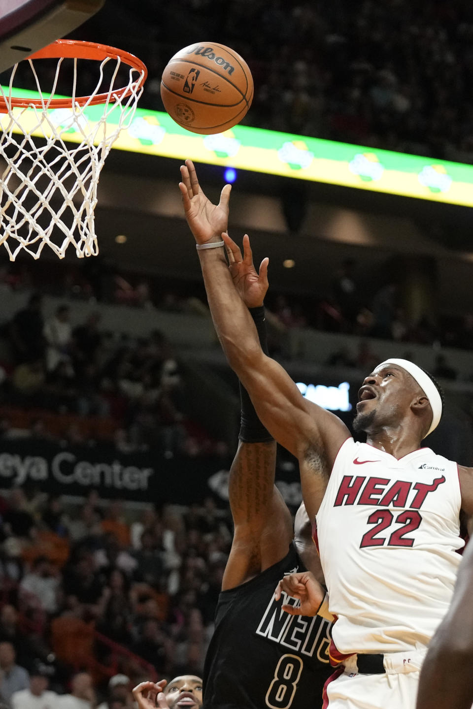 Miami Heat forward Jimmy Butler (22) goes up for a shot against Brooklyn Nets guard Lonnie Walker IV (8) during the first half of an NBA basketball game, Wednesday, Nov. 1, 2023, in Miami. (AP Photo/Wilfredo Lee)