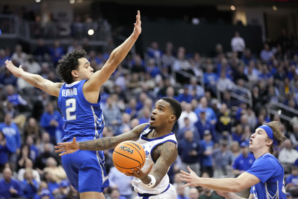 Seton Hall guard Al-Amir Dawes, center, goes to the basket against Creighton guard Ryan Nembhard (2) and guard Baylor Scheierman during the second half of an NCAA college basketball game, Wednesday, Feb. 8, 2023, in Newark, N.J. Creighton won 75-62. (AP Photo/Mary Altaffer)