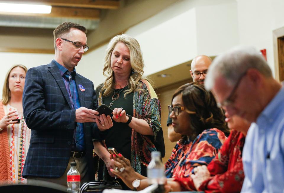'Proposition S' supporters Stephen Hall, chief communications officer; Alina Lehnert, co-chair of Friends of SPS; and Superintendent Grenita Lathan check their phones for results during an election results watch party Tuesday evening.