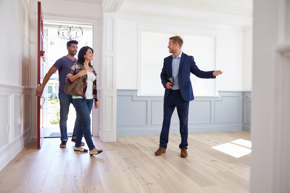 A couple looking at a home with a realtor.