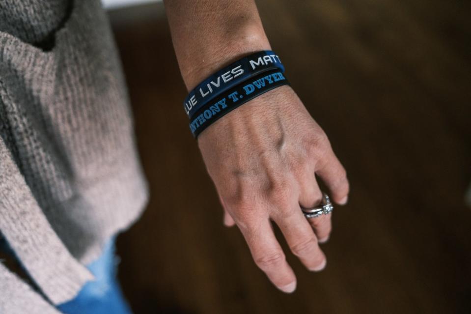 A loved one wears wristbands in memory of the fallen NYPD officer. Stephen Yang
