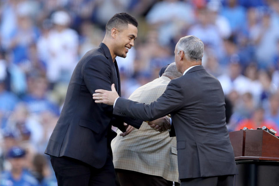 <p>Giancarlo Stanton #27 of the Miami Marlins shakes hands with Major League Baseball Commissioner Robert D. Manfred Jr. before game two of the 2017 World Series between the Houston Astros and the Los Angeles Dodgers at Dodger Stadium on October 25, 2017 in Los Angeles, California. (Photo by Christian Petersen/Getty Images) </p>