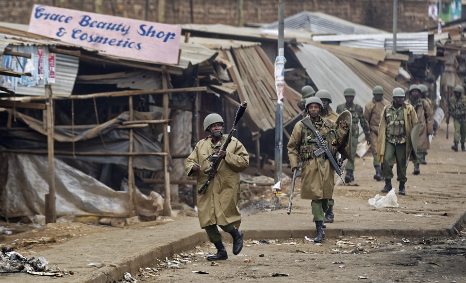 <p>Riot police chase after protesters during clashes in the Kawangware slum of Nairobi, Kenya, Thursday, Aug. 10, 2017. (Photo: Ben Curtis/AP) </p>