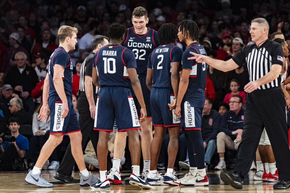 UConn players huddle during a break in the second half of an NCAA college basketball game against St. John's on Saturday, Feb. 3, 2024, in New York. UConn won, 77-64. (AP Photo/Peter K. Afriyie)