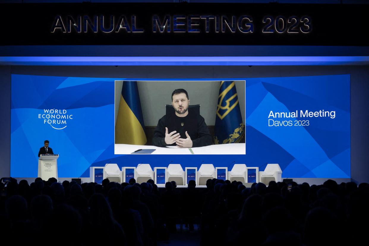 TOPSHOT - Ukrainian President Volodymyr Zelensky is displayed on a screen via video link at the Congress centre during the World Economic Forum (WEF) annual meeting in Davos January 18, 2023. (Photo by Fabrice COFFRINI / AFP) (Photo by FABRICE COFFRINI/AFP via Getty Images)