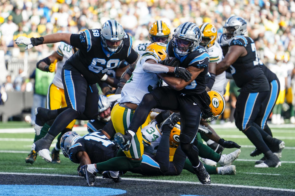 Carolina Panthers running back Chuba Hubbard scores against the Green Bay Packers during the first half of an NFL football game Sunday, Dec. 24, 2023, in Charlotte, N.C. (AP Photo/Jacob Kupferman)