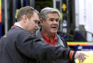 FILE - Al Unser Jr., left, talks to his father, Al Unser, before practice at the Miami-Dade Homestead Motorsports Complex in Homestead, Fla., Thursday, Feb. 28, 2002. Unser, one of only four drivers to win the Indianapolis 500 a record four times, died Thursday, Dec. 9, 2021, following years of health issues. He was 82. (AP Photo/Luis M. Alvarez, File)