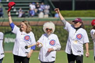 Actress Megan Cavanagh, left, who played Marla Hooch in the movie "A League Of Their Own", Tracy Reiner, right, who played Betty "Spaghetti", stand with Maybelle Blair, an original member of the All-American Girls Professional Baseball League, during a 30th anniversary of the film shot a Wrigley Field, before a baseball game between the Chicago Cubs and the Philadelphia Phillies Thursday, Sept. 29, 2022, in Chicago. (AP Photo/Charles Rex Arbogast)