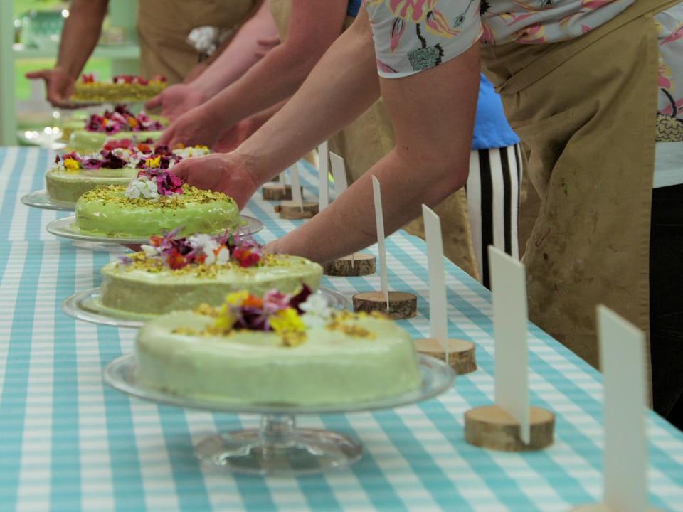 great british baking show bakers putting their desserts down during a technical bake