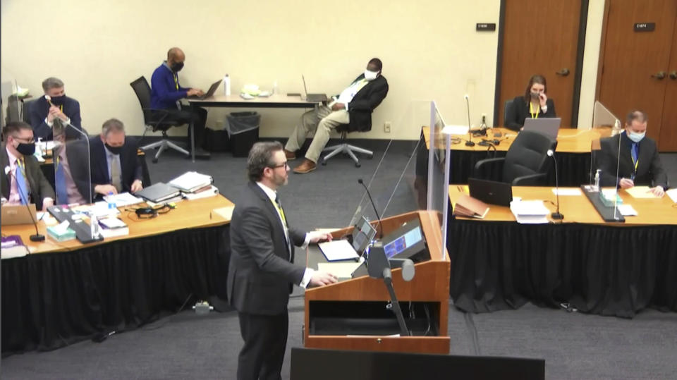 In this image taken from video, defense attorney Eric Nelson questions witness Los Angeles police department Sergeant Jody Stiger, as Hennepin County Judge Peter Cahill presides Wednesday, April 7, 2021, in the trial of former Minneapolis police Officer Derek Chauvin at the Hennepin County Courthouse in Minneapolis. Chauvin is charged in the May 25, 2020 death of George Floyd. (Court TV via AP, Pool)