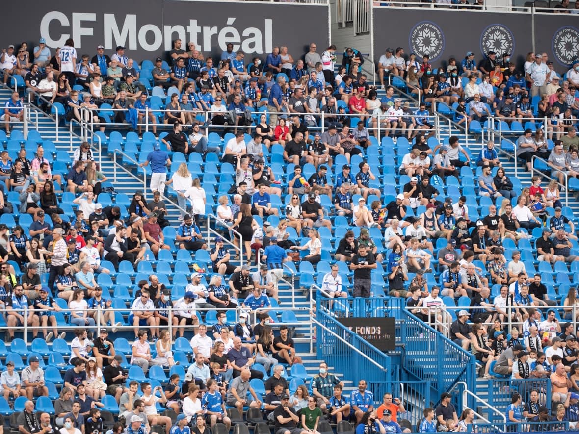 Fans sit in the stands prior to an MLS soccer game between CF Montreal and FC Cincinnati in Montreal. On Wednesday, CF Montreal announced that its visitors' fan section will be closed on Saturday in response to the brawl that took place at BMO Field in Toronto. (Graham Hughes/The Canadian Press - image credit)