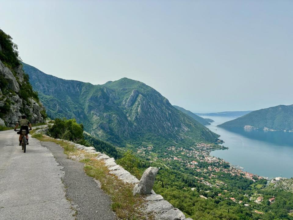 Cook is seen here riding toward the finish line, overlooking Kotor Bay in Montenegro.