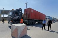 Trucks loaded with equipment for a U.S charity tent hospital, under construction, arrive into Gaza