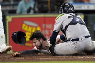 Houston Astros' Kyle Tucker, left, is tagged out by New York Yankees catcher Jose Trevino (39) while trying to steal home plate during the third inning of a baseball game Thursday, June 30, 2022, in Houston. (AP Photo/David J. Phillip)