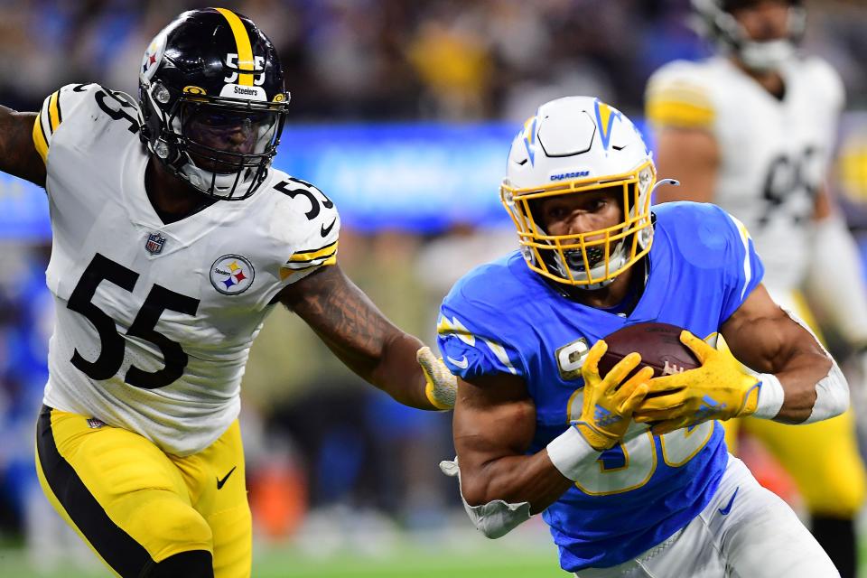 Chargers running back Austin Ekeler runs the ball ahead of Steelers linebacker Devin Bush for a touchdown.