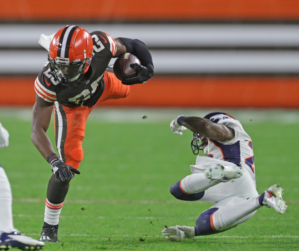 Cleveland Browns Demetric Felton is tripped up by Denver Broncos' Kareem Jackson on Thursday, Oct. 21, 2021 in Cleveland, at FirstEnergy Stadium. [Phil Masturzo/ Beacon Journal]