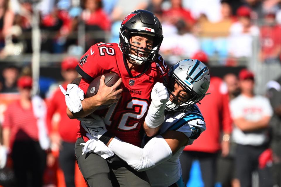 Tom Brady is tackled by Carolina Panthers linebacker Frankie Luvu.