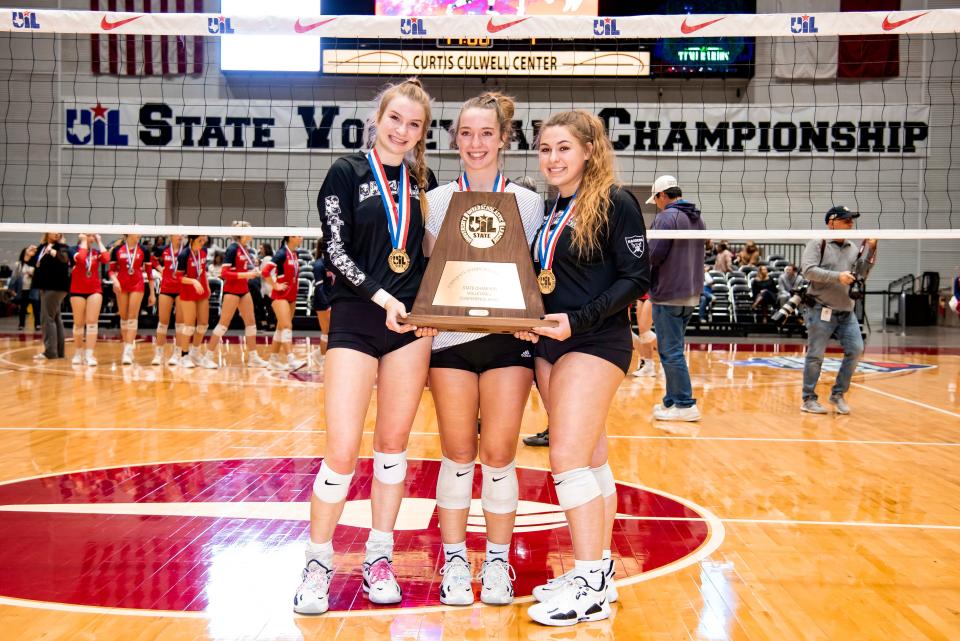 From left, Canyon Randall senior Tori Lowry (8), Canyon Randall senior Tatum Brandt (13), and Canyon Randall senior Landry Moore (16) pose for a photo with the UIL 4A State Volleyball Championship trophy after beating Aubrey at the Curtis Culwell Center in Garland, Texas on Saturday, Nov. 19, 2022. Canyon Randall won the game in three sets. (Emil Lippe/For The Amarillo Globe-News)