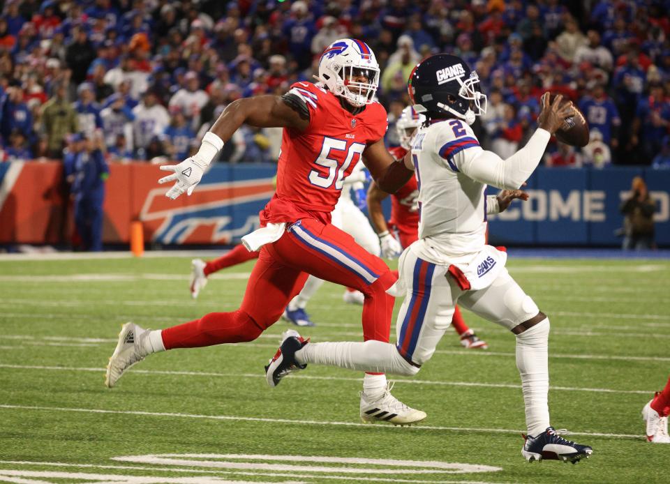 Buffalo Bills defensive end Greg Rousseau chases New York Giants quarterback Tyrod Taylor out of the pocket.