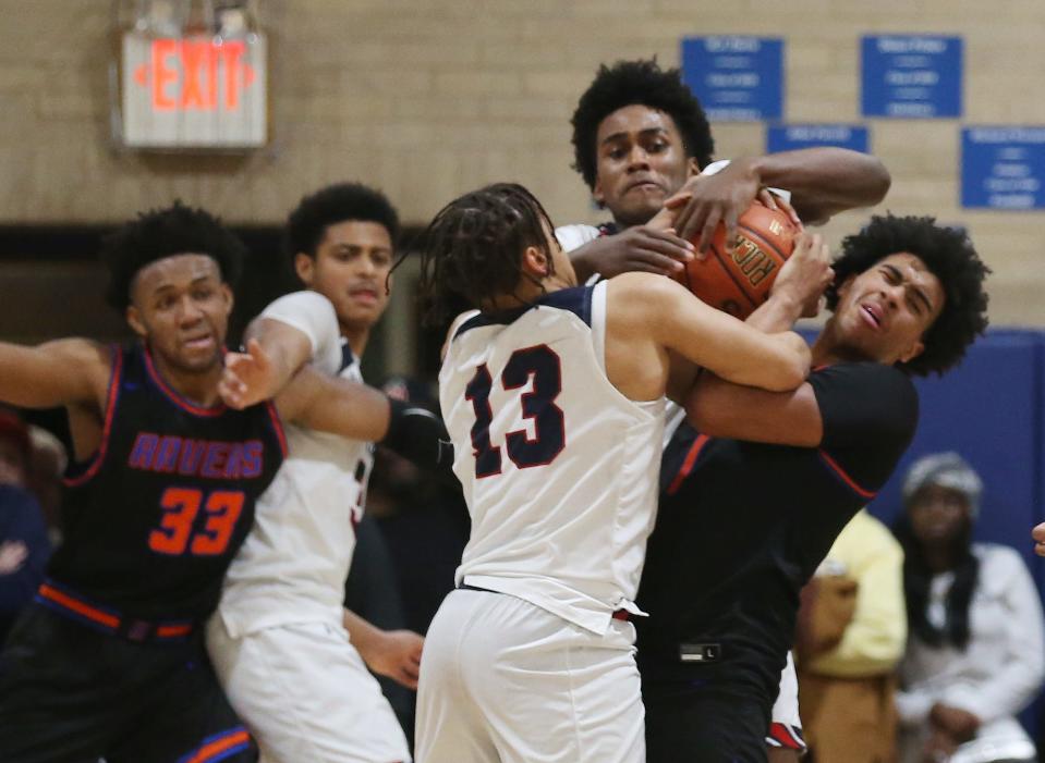 From left, Stepinac's Howard Eisley Jr. (13) and Hassan Koureissi (22) battle for a loose ball with Saint Raymond's Brandon Stores Jr. (1)  during boys basketball action at Stepinac High School in White Plains Jan. 20, 2023. Stepinac won the game 89-87 in overtime. 