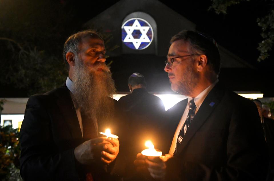 Rabbi Zvi Konikov and Rabbi Craig Mayers are pictured during the candlelight memorial, part of a prayer gathering for Israel held Oct. 10 at Temple Beth Sholom synagogue in Suntree. The interfaith gathering included several speakers, prayers, and an outdoor candlelight memorial for those lost in the recent terrorist attacks in Israel by Hamas militants.