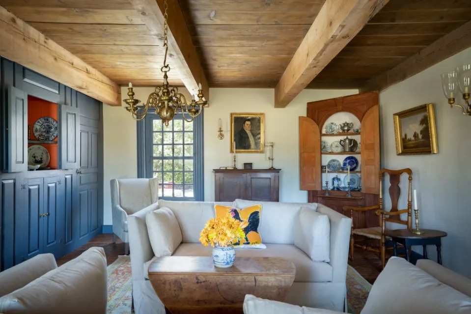 Exposed beams and a chandelier add to the charm of this gorgeous great room. Ren Nickson