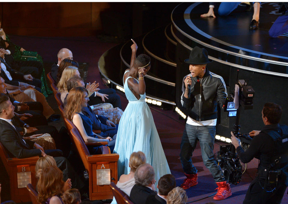 Lupita Nyong'o, left, dances along with Pharrell Williams during his performance of "Happy" at the Oscars at the Dolby Theatre on Sunday, March 2, 2014, in Los Angeles. (Photo by John Shearer/Invision/AP)