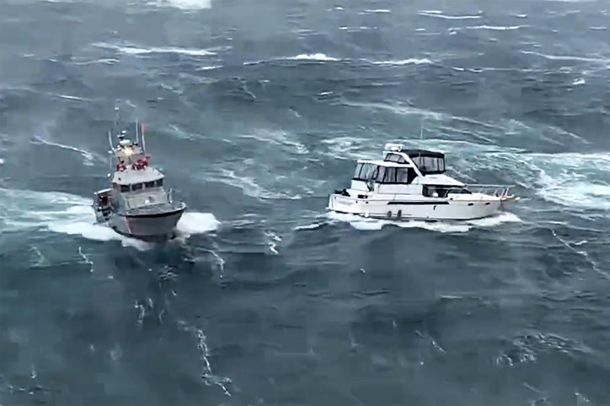 A U.S. Coast Guard vessel, left, moves to help a vessel in distress in rough waters of the Columbia River in the Pacific Northwest on Friday. (U.S. Coast Guard via Twitter)