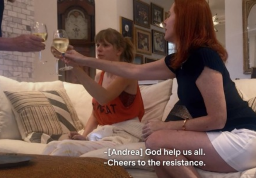 A moment from "Miss Americana" where people are giving a toast and someone says "God help us all, cheers to the resistance"