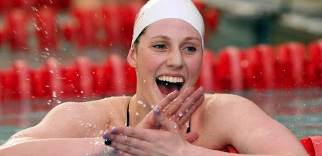 Missy Franklin celebrates while wearing her Regis Jesuit cap — AP