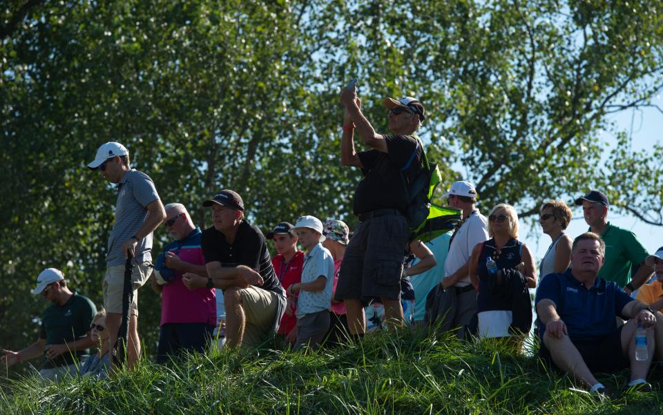 Fans perch up on a hill to view the 16th hole green during the fourth round of the Korn Ferry Tour Championship at Victoria National Golf Club in Newburgh, Ind., Sunday afternoon, Sept. 5, 2021. 