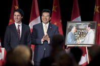 Prime Minister Justin Trudeau stands with China’s Ambassador to Canada Luo Zhaohui after being presented a photo of his father, former prime minister Pierre Elliot Trudeau, meeting Chairman Mao Zedong, during a celebration of 45 years of Canada-China diplomatic relations, in Ottawa on Jan. 27, 2016. THE CANADIAN PRESS/Justin Tang