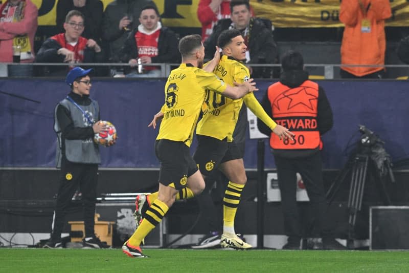 Borussia Dortmund's Jadon Sancho (R) celebrates his side's first goal fo the game with Salih zcan during the UEFA Champions League Round of 16, second leg soccer match between Borussia Dortmund and PSV Eindhoven at Signal Iduna Park. Bernd Thissen/dpa