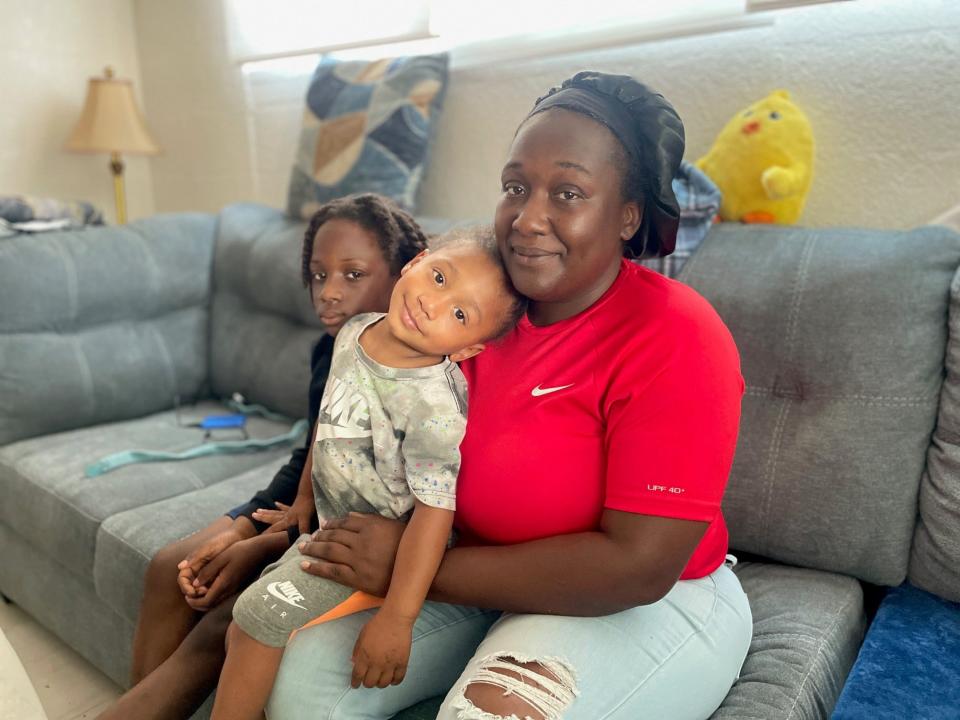 Anqunette Harvey holds 3-year-old Andre Harvey next to her son Andrew, 8.