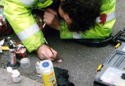 Ben Wilson painting on the sidewalk. (Photo courtesy of Rahid Khan / Flickr.)