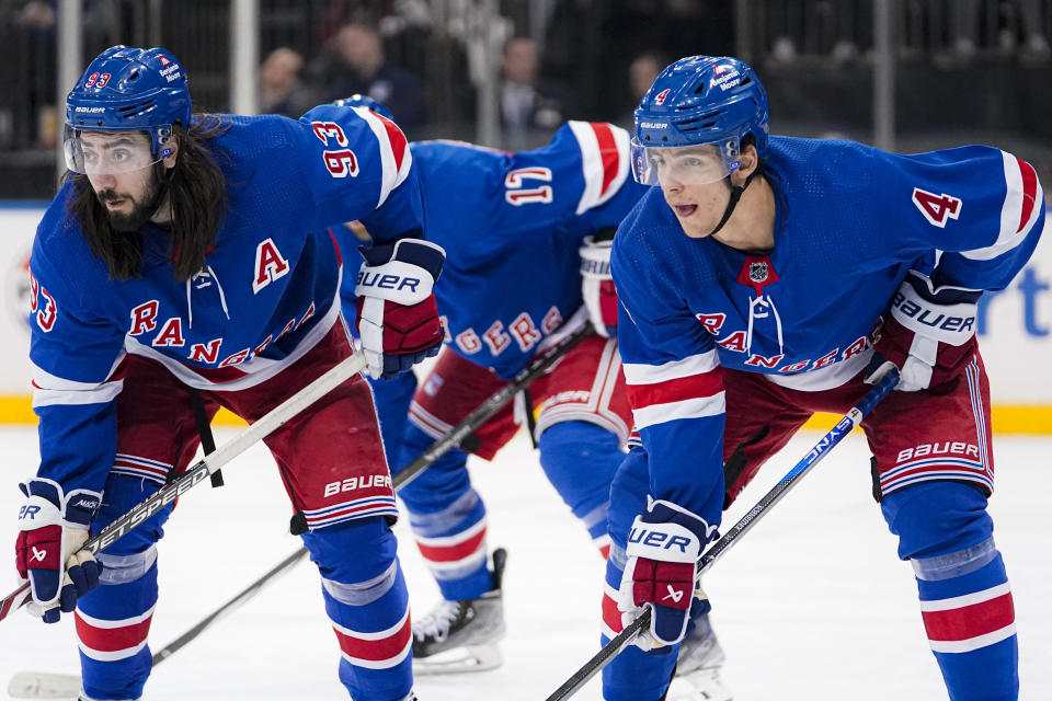 New York Rangers center Mika Zibanejad (93) and defenseman Braden Schneider (4) await a faceoff during the first period of the team's NHL hockey game against the Edmonton Oilers in New York, Friday, Dec. 22, 2023. (AP Photo/Peter K. Afriyie)