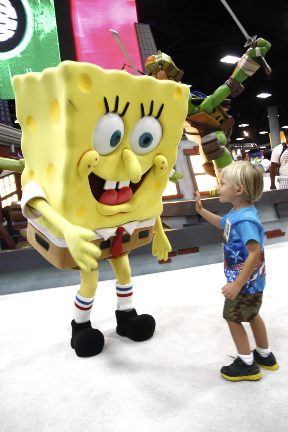 FILE - In this July 15, 2012 publicity photo provided by Nickelodeon, a fan is seen with SpongeBob SquarePants during Comic-Con, in San Diego, Calif. Storm Troopers, cyborgs, superheroes and other comic-book fans can count on their annual pilgrimage to San Diego for another four years. San Diego Mayor Jerry Sanders announced Monday, Oct. 29, 2012, that Comic-Con has extended its contract with the city through 2016. (AP Photo/Nickelodeon, Joe Kohen, File)