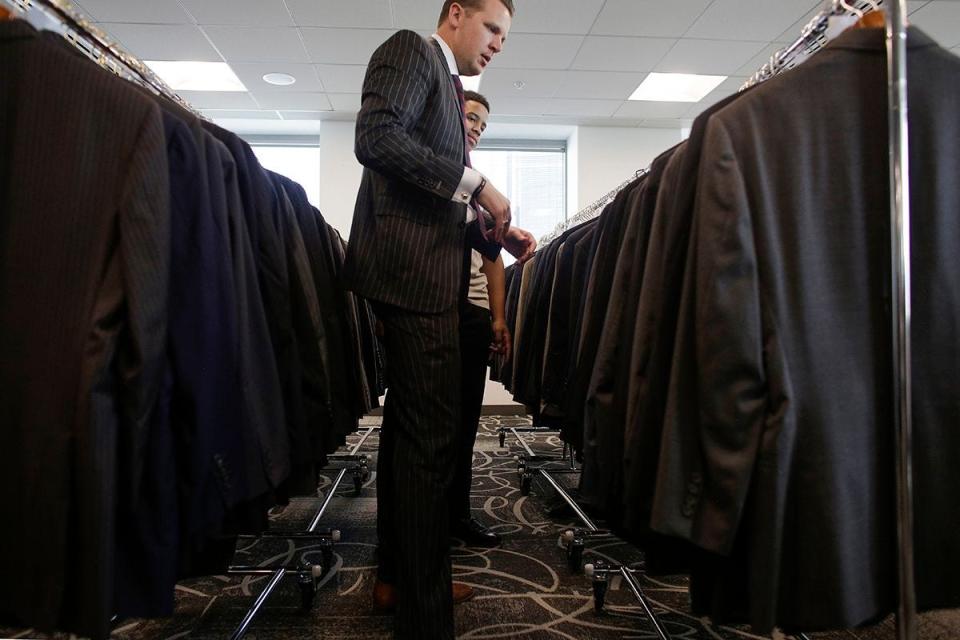 Brent Ballance of Tom James Custom Suits helps a customer get fitted for a suit in Detroit on March 23, 2019.