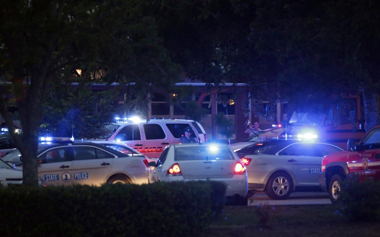 Police cars gather at the scene where a gunman opened fire and killed 11 people - FR41444 AP