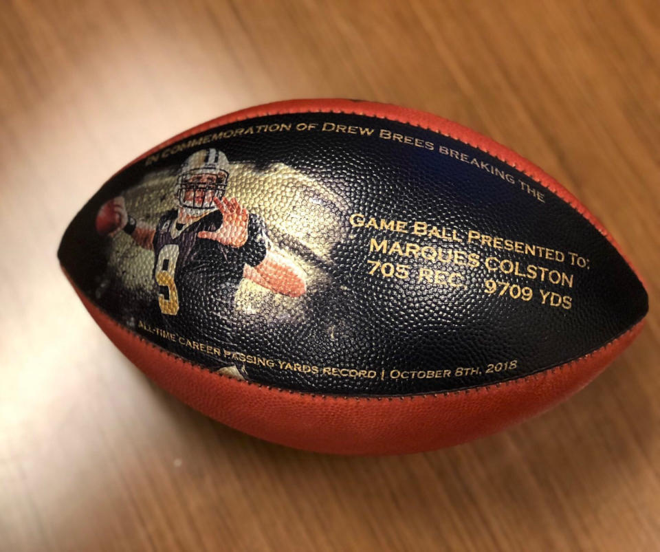 This undated photo provided by the New Orleans Saints shows a custom made football. When Drew Brees became the NFL’s all-time leader in yards passing, he wanted to come up with some sort of gift to thank those who coached him, caught the 6,357 completions it took to set the record, and those who blocked while he threw. His solution was an exhaustive process than involved the production of about 175 unique commemorative footballs and the enlisting Saints front office and public relations staff to help track down 99 receivers, 56 offensive linemen, 11 head or assistant coaches from his 18 pro seasons, as well as a few others Brees saw as instrumental in his success. (New Orleans Saints via AP)