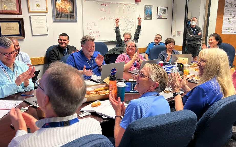 Members of the Voyager mission team celebrate after engineering data returns from the spacecraft for the first time since November 2023