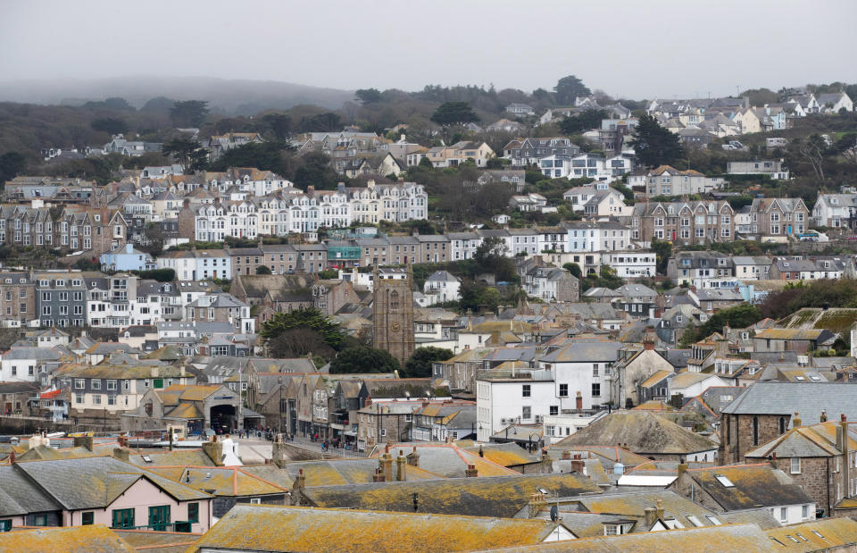 ST IVES, ENGLAND - OCTOBER 10:  Properties in the town of St Ives, which has introduced measures to limit the number of second homes, are seen in St Ives on October 10, 2017 in Cornwall, England. Following on from St Ives the picturesque Cornish coastal fishing village of Mevagissey has also submitted plans to Cornwall Council to block outsiders buying new-builds to use as holiday homes in an attempt to give local first-time buyers better chances of getting on the property ladder rather than being outbid by wealthy second home owners. The village's Neighbourhood Development Plan has highlighted that currently twenty six per cent of the homes in Mevagissey are holiday homes with average prices, according to Rightmove, of £299,587, nearly £50,000 more than the Cornish average of £250,000, and 20 times the local average wage of £15,458. It also noted that although since 1930 the buildings in the village have more than doubled, the permanent population of Mevagissey has actually fallen over the last 200 years. If the plans are approved they will be returned to the village to be voted on in a referendum and will follow attempts by other communities in Cornwall which have introduced new-build bans including most notably St Ives.  (Photo by Matt Cardy/Getty Images)