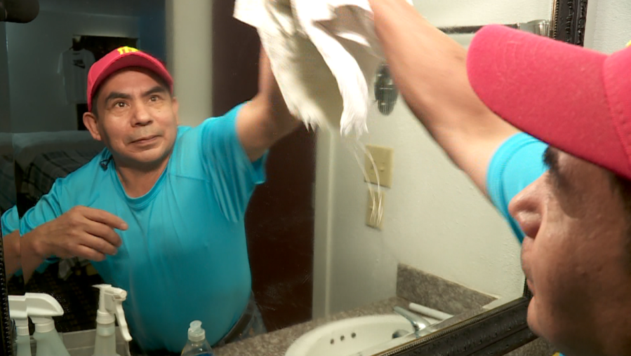 Manuel Diaz cleans a room at Executive Inn in Edmond. Photo: KFOR.