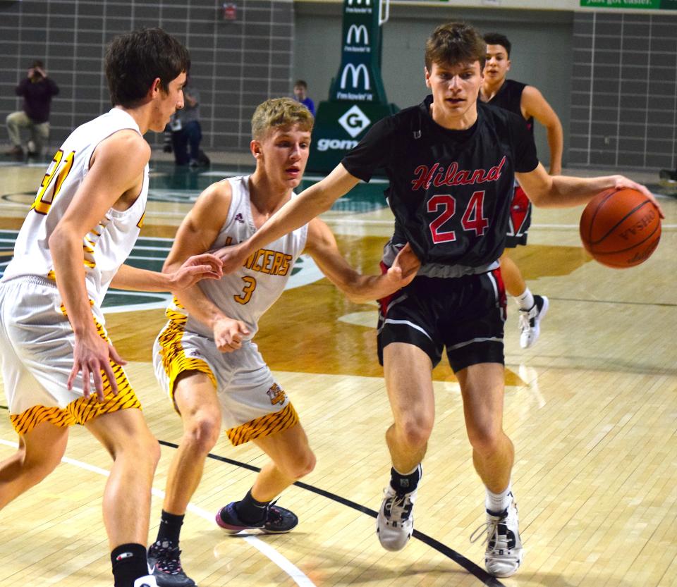 Nick Wigton drive past a pair of Federal Hokcing defenders during first half action of the Hawls' 55-51 Athens Regional semifinal.