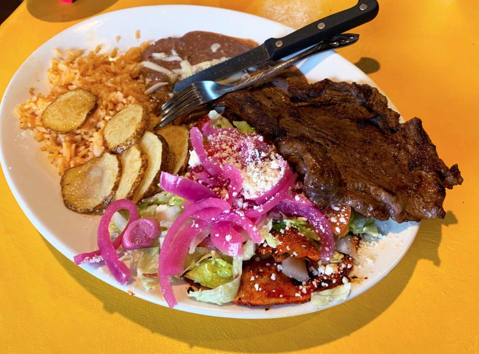 Enchiladas estilo Michoacan at Mama Lupitas come with a slab of carne asada.