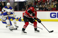 Carolina Hurricanes' Sebastian Aho (20) controls the puck in front of Buffalo Sabres' Tage Thompson (72) during the second period of an NHL hockey game in Raleigh, N.C., Thursday, April 7, 2022. (AP Photo/Karl B DeBlaker)