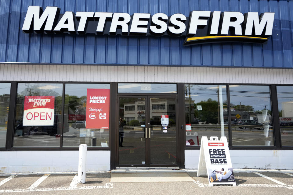 A Mattress Firm store location has an open sign in a window, Tuesday, May 9, 2023, in Dedham, Mass. Tempur Sealy has agreed to acquire Mattress Firm in a cash-and-stock transaction valued at about $4 billion. The companies said Tuesday they expect to complete the transaction in the second half of 2024. (AP Photo/Steven Senne)