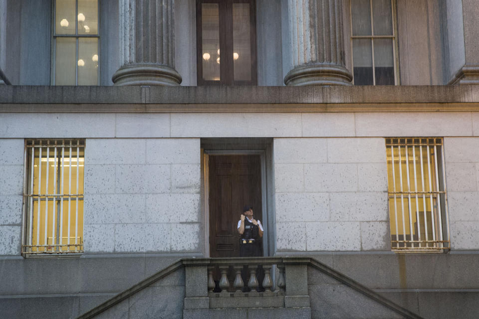 A Uniformed Division Secret Service officer looks up at the rain as he takes shelter in a doorway of the Treasury Building, Monday, July 8, 2019, in Washington. (Photo: Alex Brandon/AP)