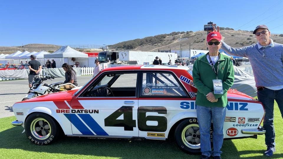 john morton gets bunny ears from a friend next to a datsun